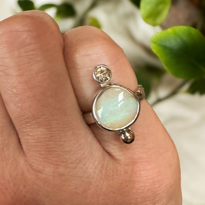 Opal and rutile quartz ring on hand, one of a kind handcrafted Natural Earth Collective Ohio
