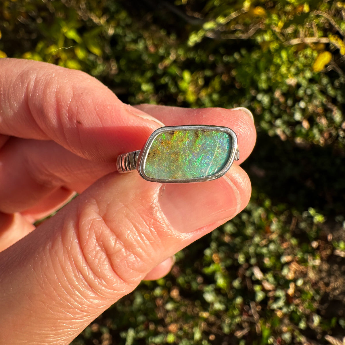 Green Boulder Opal ring on hand, one of a kind handcrafted Natural Earth Collective Ohio