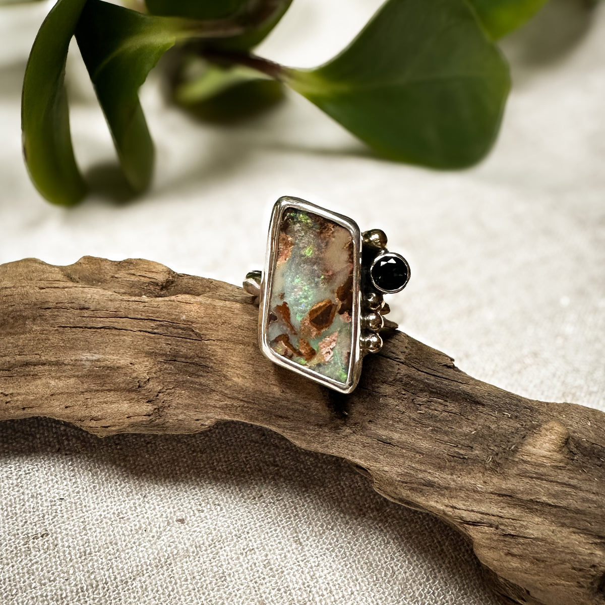 Boulder Opal and blue topaz ring on hand, one of a kind artisan Natural Earth Collective Ohio