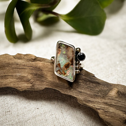 Boulder Opal and blue topaz ring on hand, one of a kind artisan Natural Earth Collective Ohio