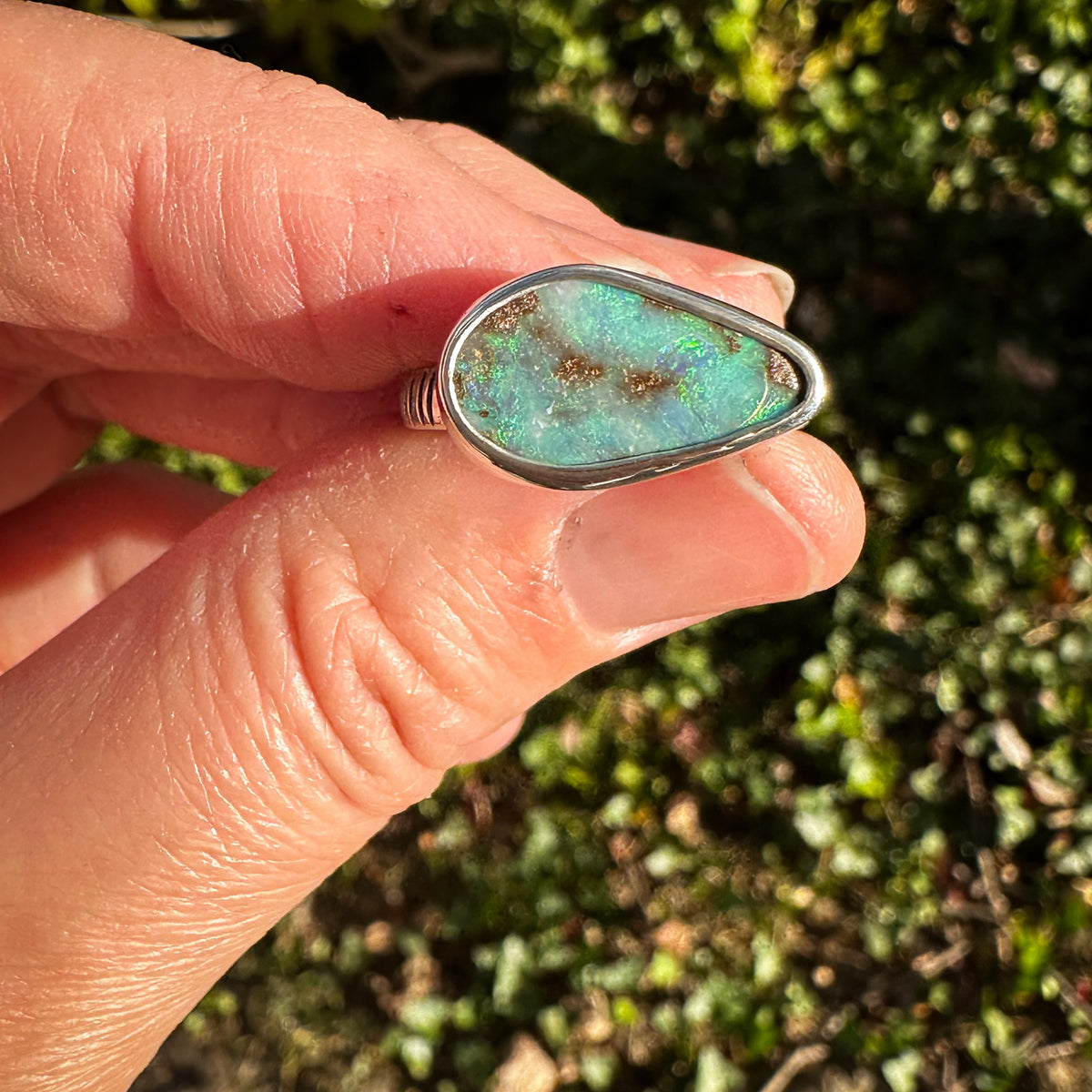 Blue Boulder Opal ring on hand, one of a kind handcrafted Natural Earth Collective Ohio