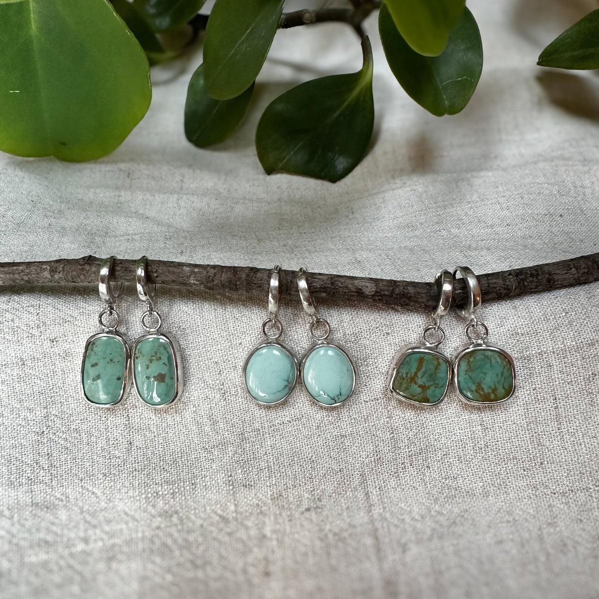 Lone Mountain Turquoise hinge hoop earrings on ear, one of a kind Natural Earth Collective Ohio