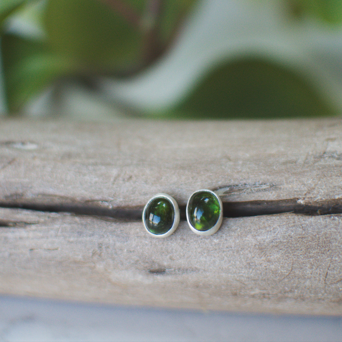 Natural tourmaline stud earrings styled on ear, colorful gemstone Natural Earth Collective Ohio