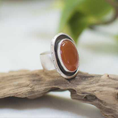 Orange Chalcedony ring on hand, one of a kind handcrafted Natural Earth Collective Ohio