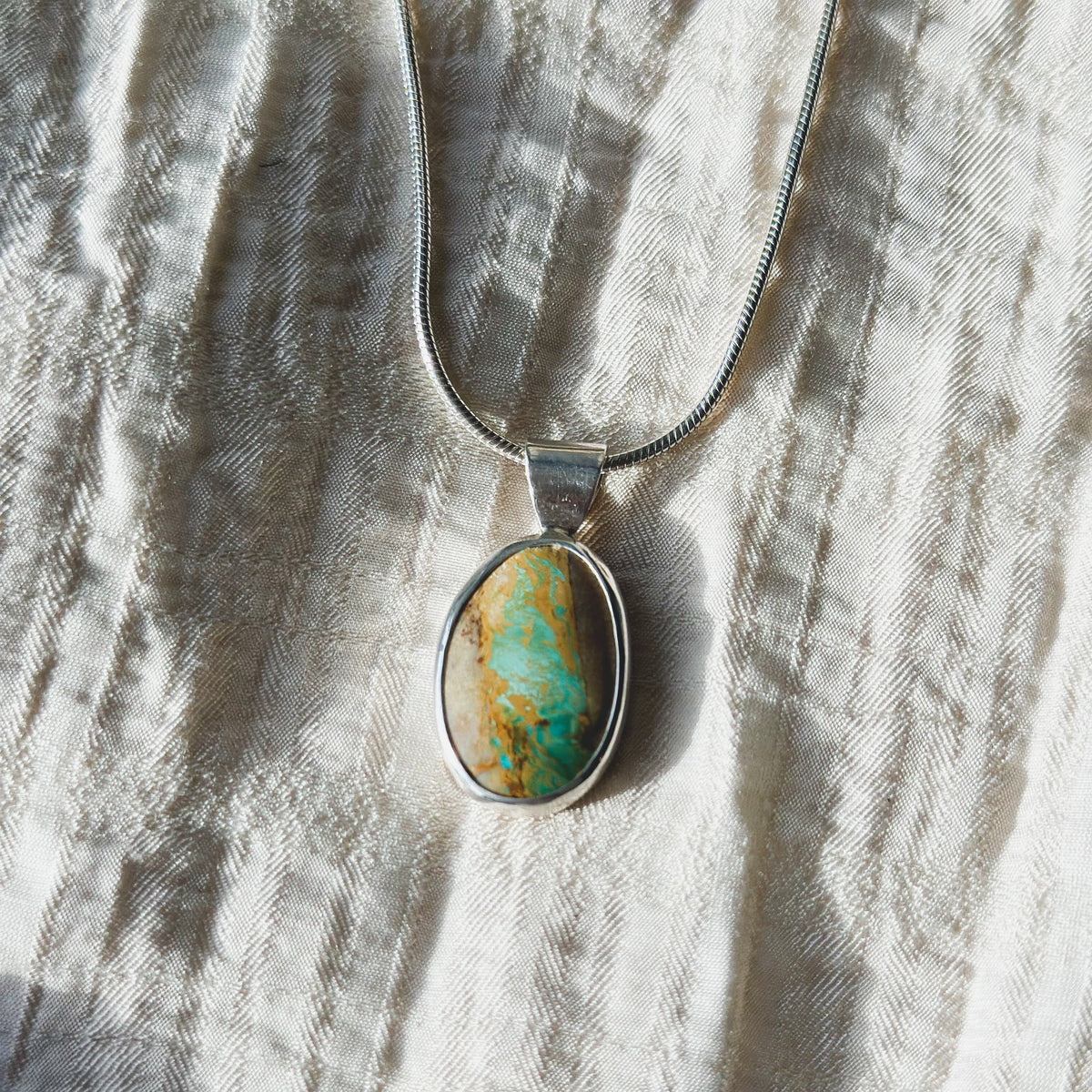 Royston Ribbon Turquoise pendant close up, banded ribbon matrix Nevada turquoise Natural Earth Collective Ohio