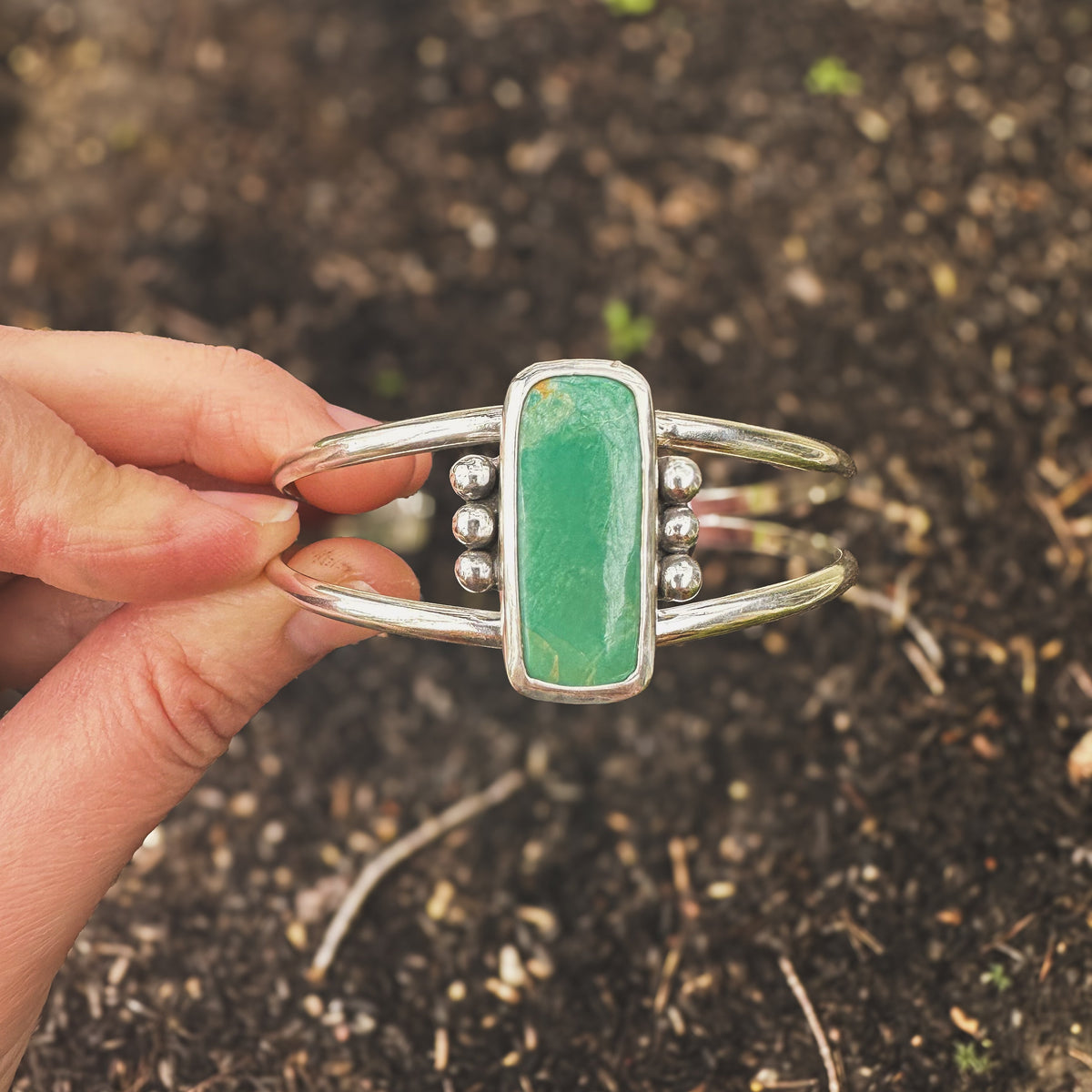 Green River statement cuff on wrist, one of a kind handcrafted Natural Earth Collective Ohio